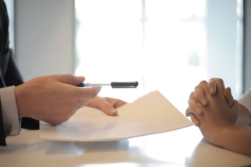 businessman giving-contract to woman to sign